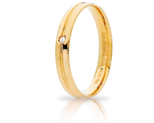 Fede Nuziale Unoaerre Lyra in oro giallo con diamante